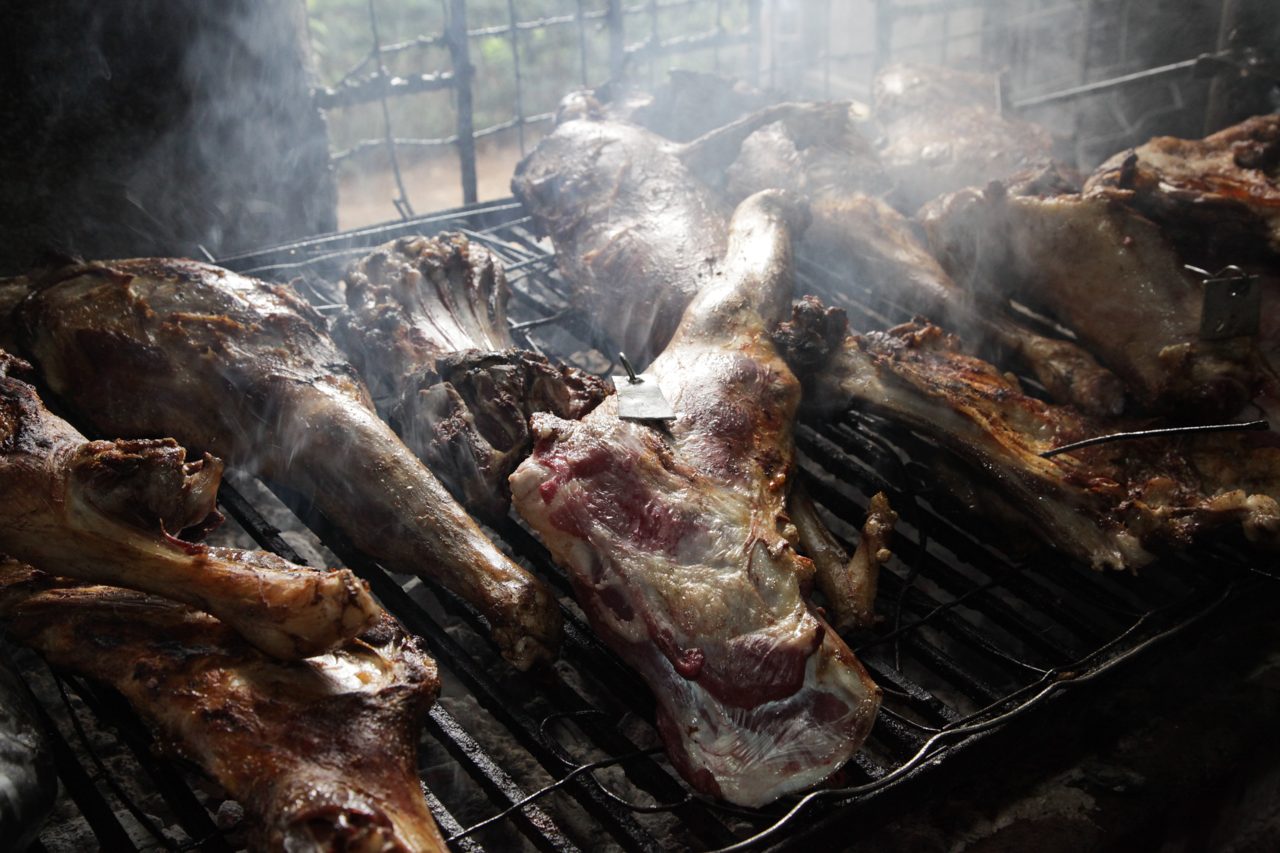 Goat slow-roasting over the fire